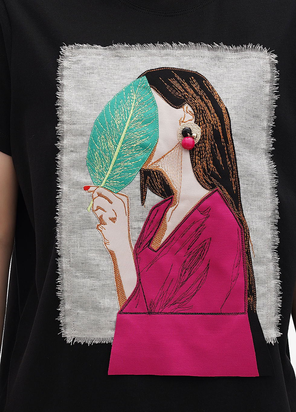 Thumbnail: Female model wearing a designer t-shirt with a vibrant graphic