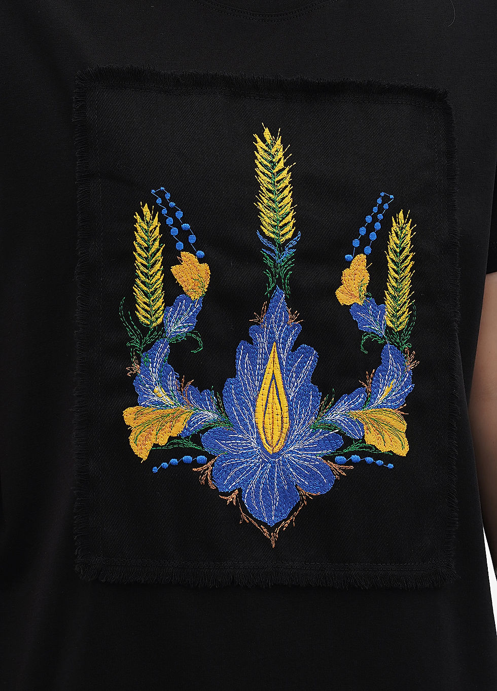 Thumbnail: Female model wearing a designer t-shirt with a vibrant graphic.