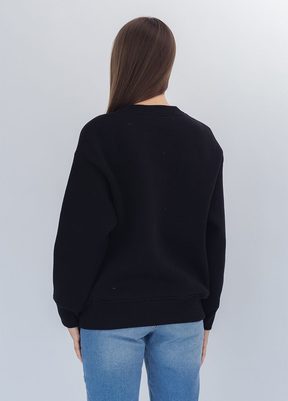 Thumbnail: Female model wearing a designer sweatshirt with a vibrant graphic.