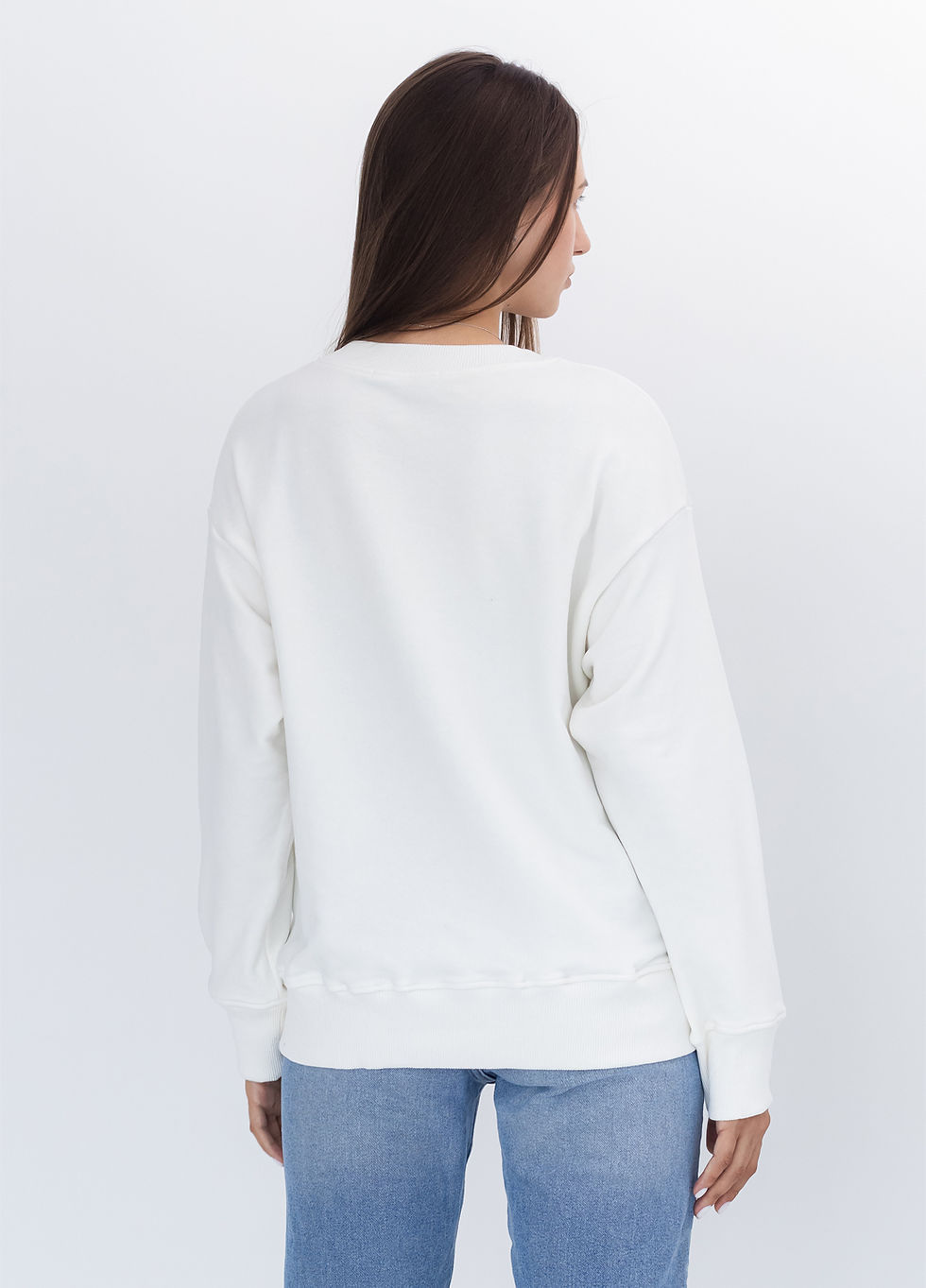 Female model wearing a designer sweatshirt with a vibrant graphic.