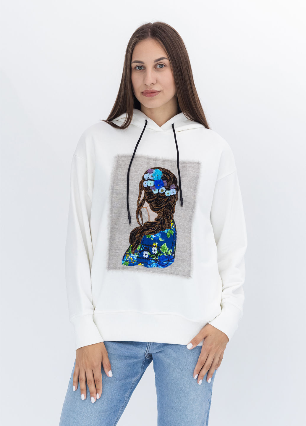 Female model wearing a designer hoodie with a vibrant graphic
