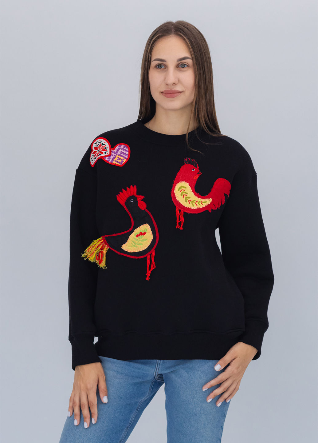Female model wearing a designer sweatshirt with a vibrant graphic.