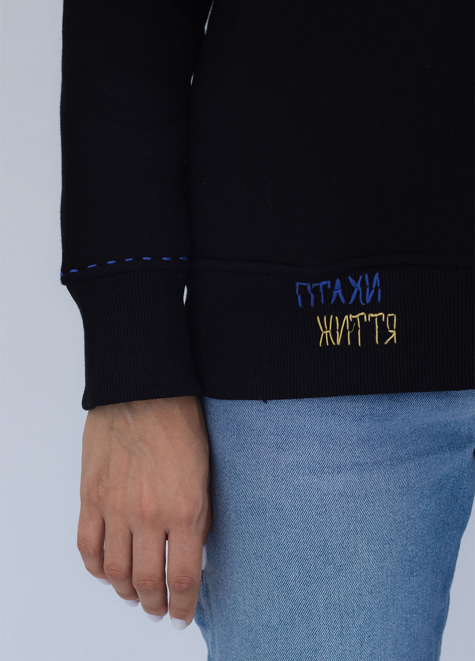 Прев'ю: Female model wearing a designer hoodie with a vibrant graphic