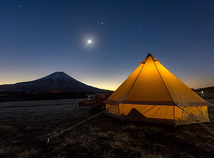 Yert with a mountain and the moon in the background