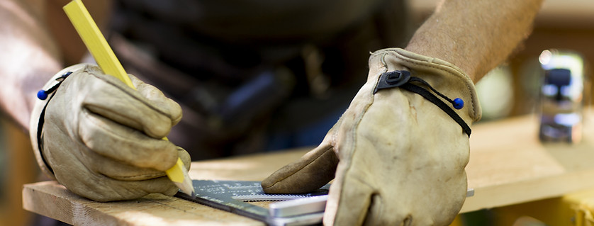 Carpenter Measuring Wood