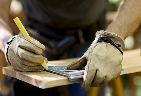 Carpenter Measuring Wood