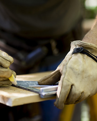 Carpenter Measuring Wood