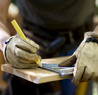 Carpenter Measuring Wood