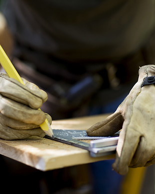 Carpenter Measuring Wood