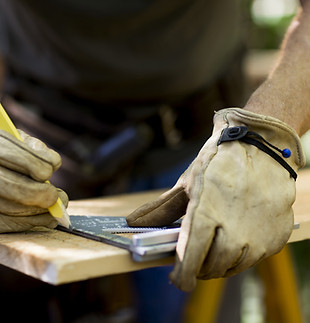 Carpenter Measuring Wood