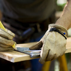 Carpenter Measuring Wood