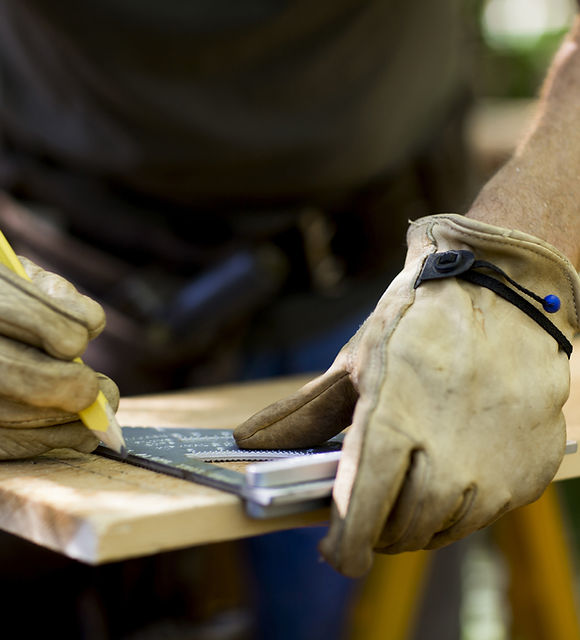 Carpenter Measuring Wood