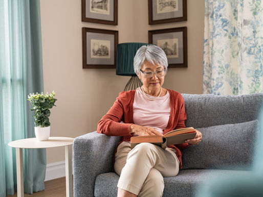 elderly lady reading on couch