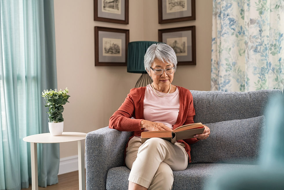 elderly lady reading on couch