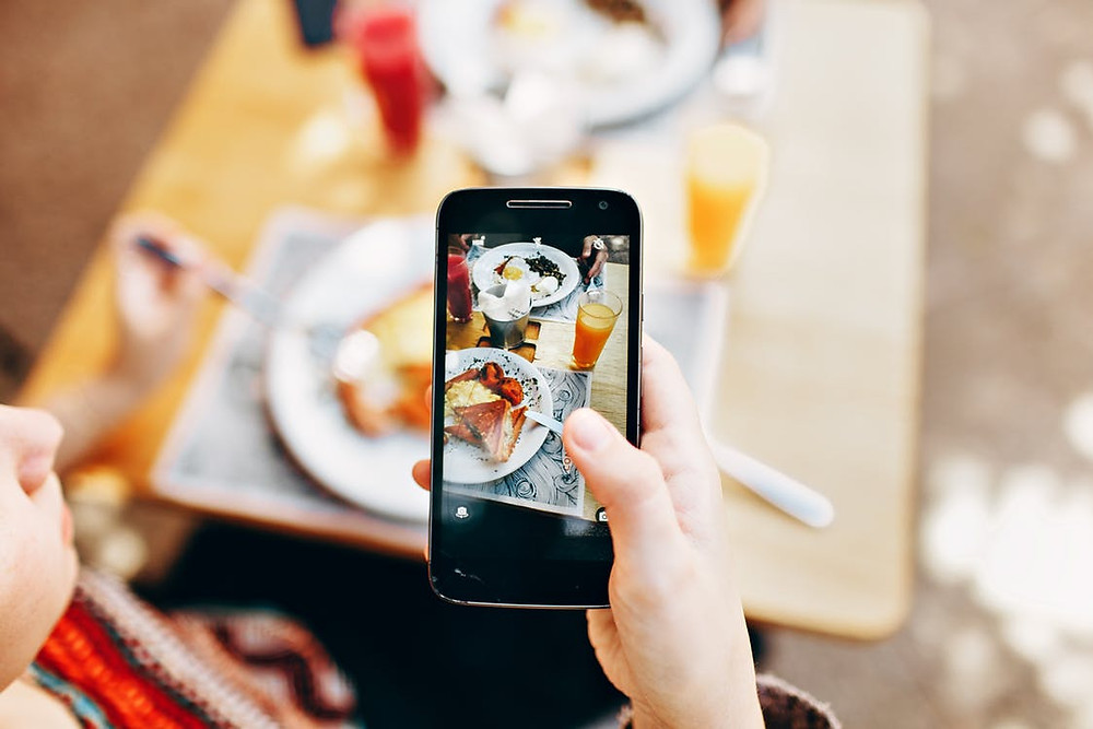 cell phone taking picture of meal