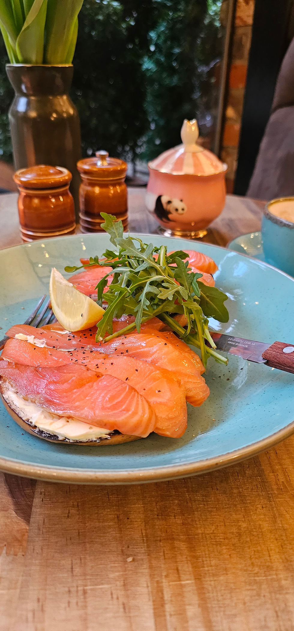 Eye-level view of a rustic small town cafe interior with wooden tables and soft lighting