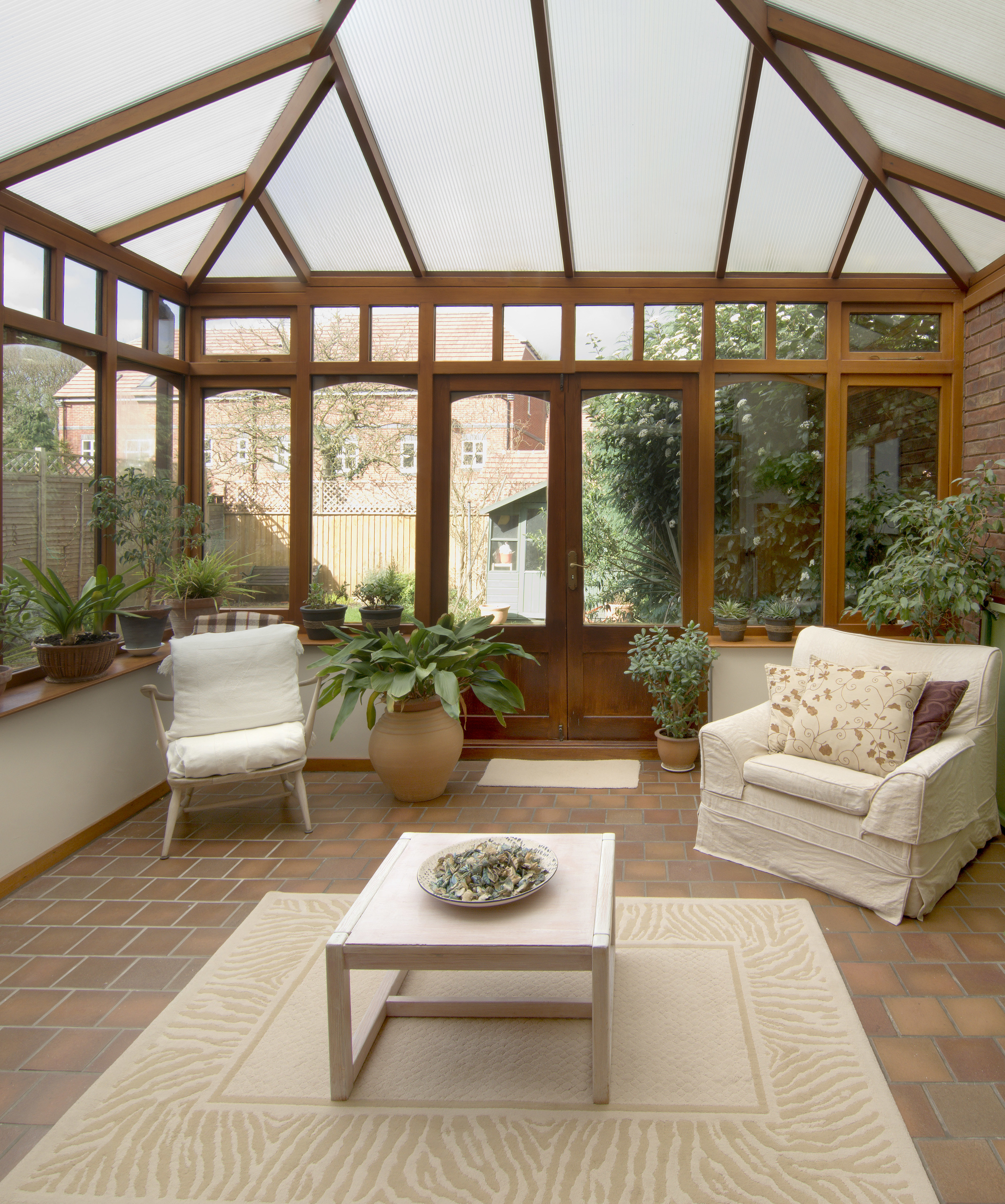 Inside a bright glass conservatory