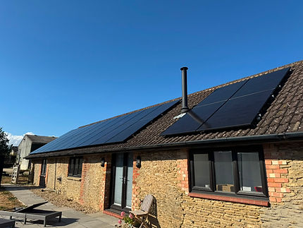 Solar panels fitted across the pitched roof of a stone home