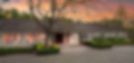 Elegant home exterior with mature tree, manicured hedges, and beautiful sunset backdrop.