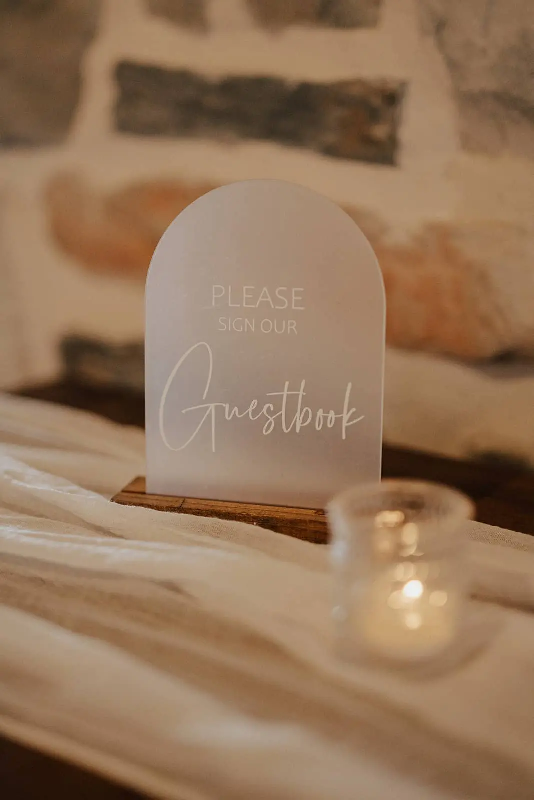 Two oversized, opulent floral arrangements resting on historic oak barrels at the ceremony entrance of the barn at silverstone luxury wedding venue.