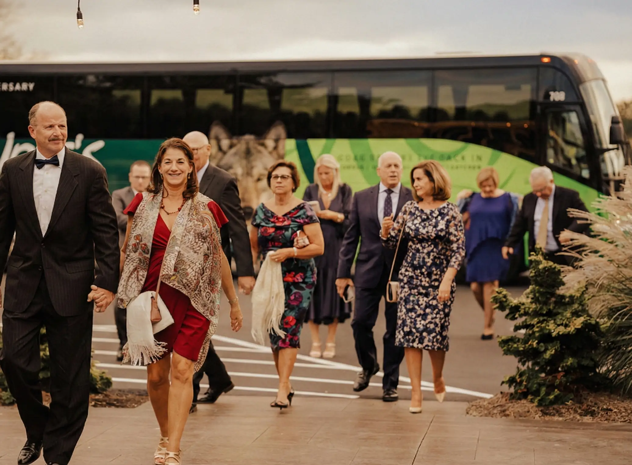 luxury coach bus providing seamless wedding guest transportation outside the historic stone walls of The Barn at Silverstone in Lancaster, PA.