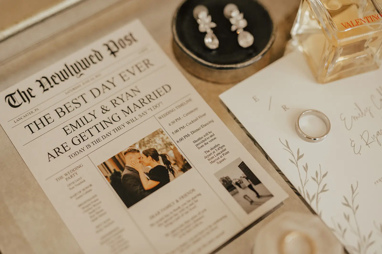 Elegant custom wedding invitation suite featuring a newspaper-style announcement and wax seal for a luxury wedding at The Barn at Silverstone in Lancaster, PA.