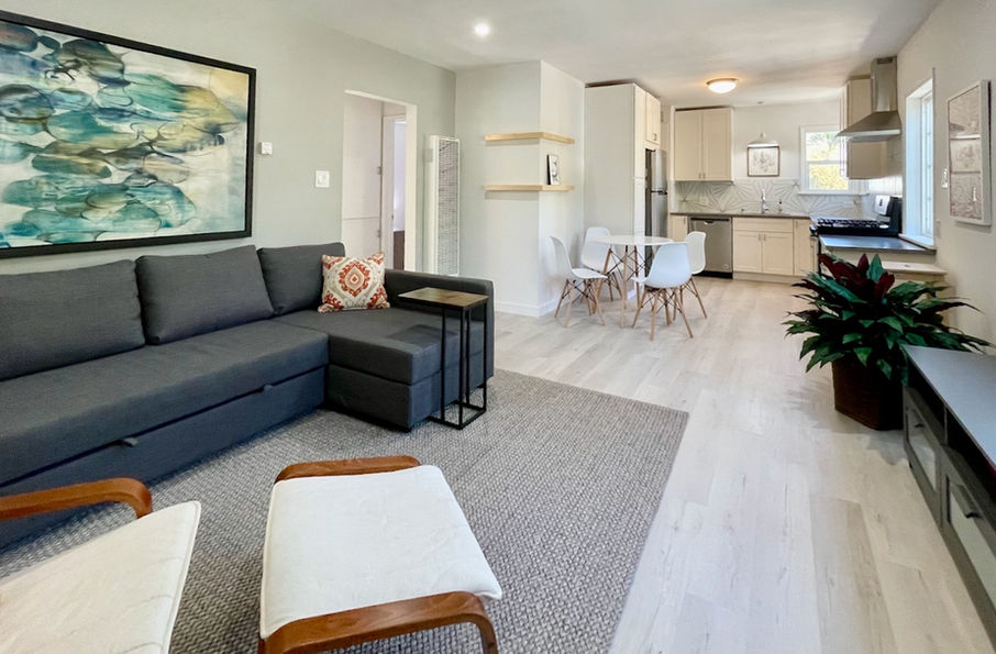 WIDE-OPEN PLAN LIVING SPACE WITH BEACH-TONED FLOORING AND CEILING FAN IN SANTA MONICA RENTAL APARTMENT RENOVATION