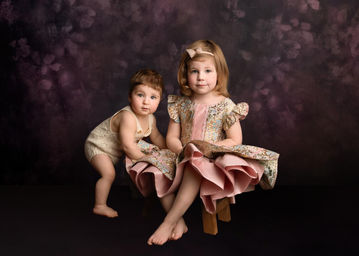 Fine-art style sibling portrait against a pink floral background by Christchurch Family Photographer, Kirsten Naomi Photography