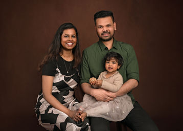 Family portrait of parents and their young daughter during a professional studio session by Christchurch family photographer Kirsten Naomi Photography