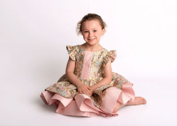 Portrait of a young girl in a pink ruffled dress during a professional child photography session by Christchurch family photographer Kirsten Naomi Photography