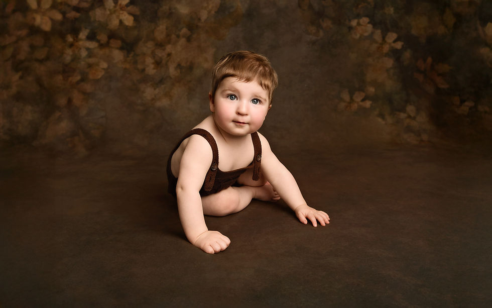 Fine-art style portrait of a baby boy in a brown romper by Christchurch Baby Photographer Kirsten Naomi Photography
