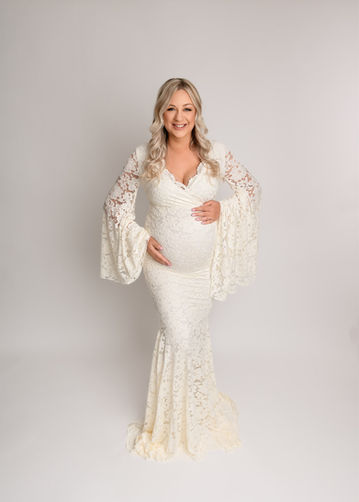 The fitted lace bodice of this gown is beautifully offset by the flowing fabric at the sleeves; it's simply stunning and perfect for this glowing mum-to-be, portrait by Christchurch maternity, newborn and baby photographer Kirsten Naomi Photography