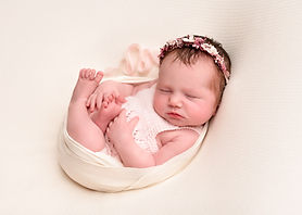 Newborn baby girl in a floral headband by Christchurch Newborn Photographer Kirsten Naomi Photography