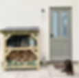 Small log and boot store with logs and boots stored inside by a back door