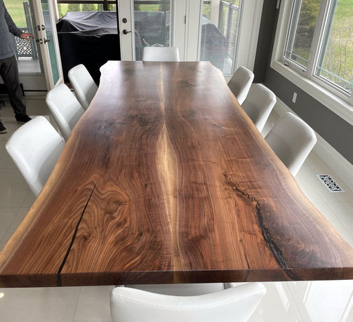 Live edge dining table set with chairs in bright dining room