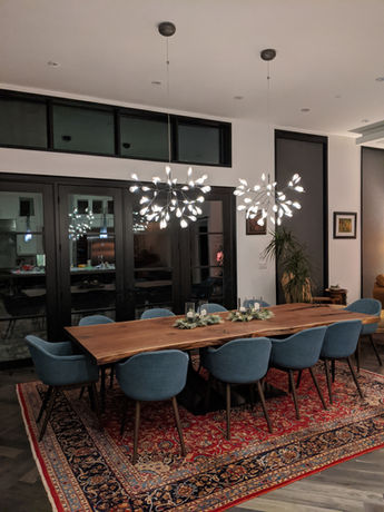 Cherrywood Studio black walnut dining table with a custom railroad track steel base, handcrafted for a modern dining space in Newmarket, Ontario