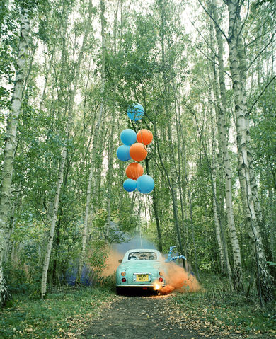 green car and colourful balloons