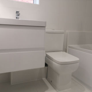 Modern bathroom installation with walk-in shower and wall-hung vanity in Witney