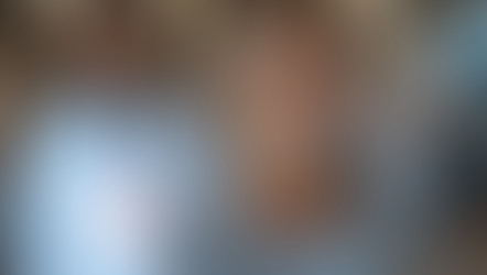Smiling middle-aged woman in a cozy sweater standing in a bright medical clinic, with a blurred doctor in the background and floating holographic graphics representing cellular regeneration.        Ask ChatGPT