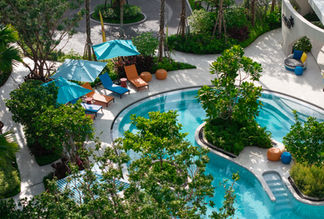 Island pool surrounded by tropical greenery at Kave COCO Bang Saen.