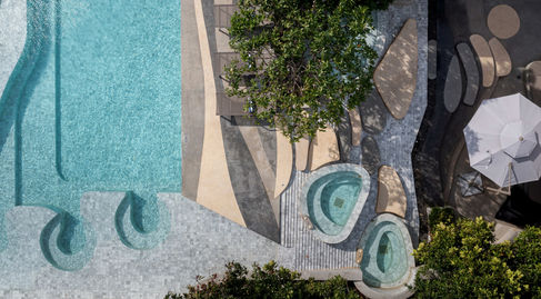 Aerial view showing main pool and jacuzzi blending with sea horizon at Bayphere Hotel Pattaya.