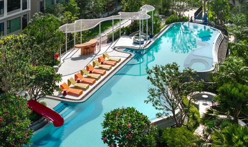 Aerial view showing pool, seating, and green landscape at Kave COCO Bang Saen.