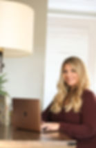 Image of female author sitting at computer desk