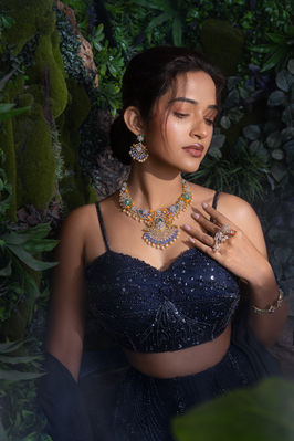 Woman in dark blue lehenga with ornate gold jewelry photography in Bangalore