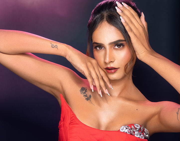 Woman in red dress posing for personal portfolio.
