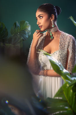 Model in bridal jewelry and white embellished gown shot by Karthik Sugutoor