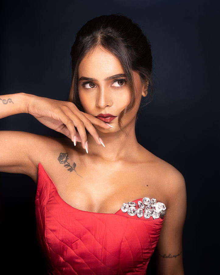 Woman in red dress posing for personal portfolio