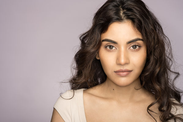 Woman with long wavy hair in a portfolio headshot