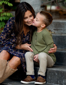 Mother and son sitting on steps for family portraits.