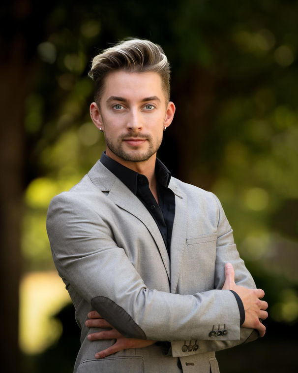 Professional branding headshot of a man in a grey suit.